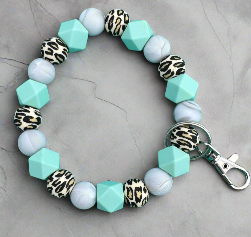 A leopord print, blue and marble color silicone beaded wristlet keychain.