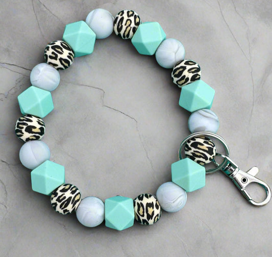 A leopord print, blue and marble color silicone beaded wristlet keychain.
