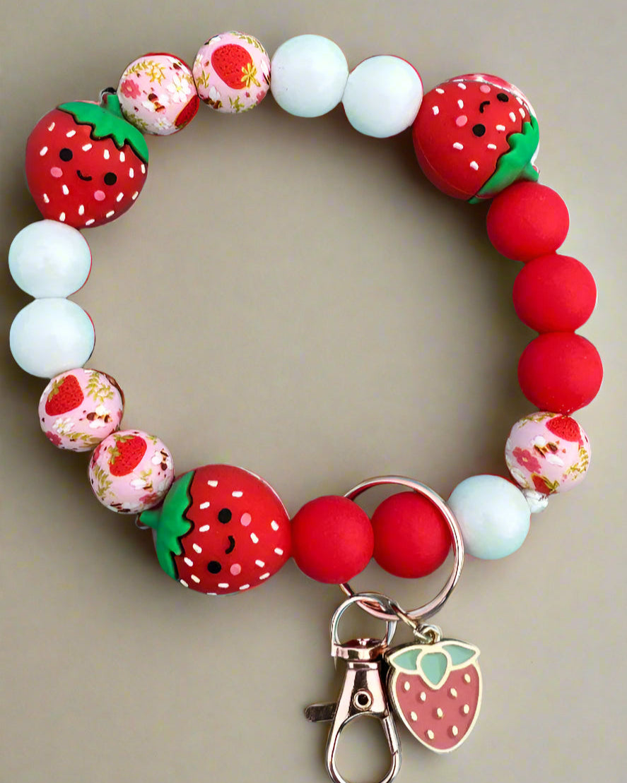 A silicone wristlet keychain with strawberry character